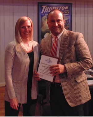 two people holding an award